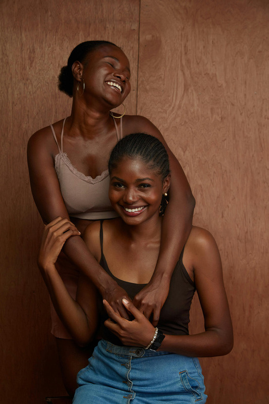 Two young women laughing together